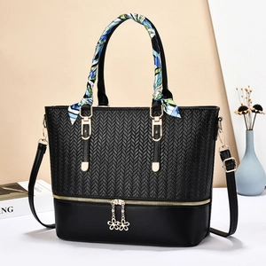 Chic black tote bag with herringbone texture, gold hardware and decorative silk scarf detail