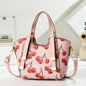 Pink cherry print dumpling bag with golden metal hardware and adjustable shoulder strap