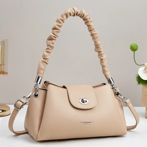 Detail of apricot large capacity handbag with scrunchie cloud handle and silver clasp