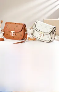 Detail view of stylish saddle bags in brown and beige with T-shaped metal twist lock