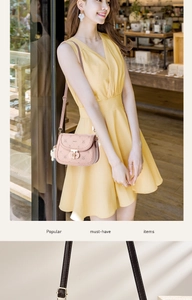 Detail of pink saddle bag featuring embossed pattern, metal clasp and adjustable strap
