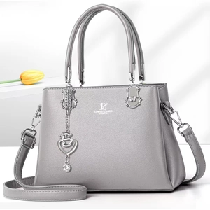 Elegant grey pebbled leather handbag with silver S-heart charm and crossbody strap