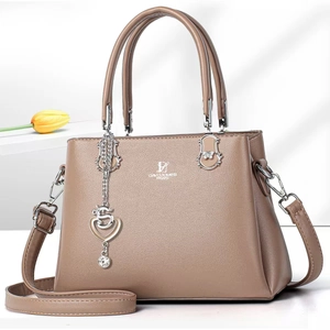 Detailed view of khaki pebbled leather handbag with silver heart charm and tulip decor