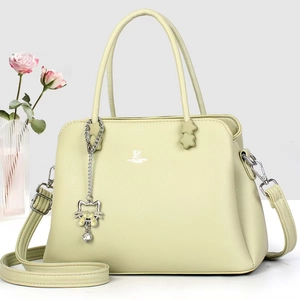 Elegant light green pebble leather handbag with top handles and cat charm detail