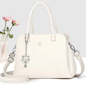 Detail of David Jones beige lychee leather handbag with silver cat charm and brand logo
