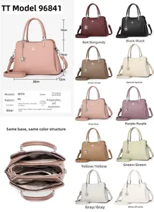 Detail view of multi-compartment PU leather handbag with 28x12x19cm dimensions