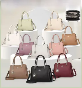 Detailed interior view of litchi leather handbag with three functional compartments