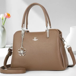 Elegant coffee brown lychee textured handbag with adjustable strap and floral pendant