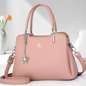 Elegant dusty pink litchi grain leather handbag with adjustable crossbody strap