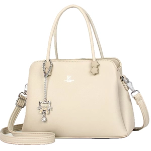 Chic beige textured leather handbag for women with cat charm and adjustable shoulder strap