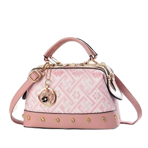 Pink geometric jacquard tote bag with leather straps and heart charm in a front view