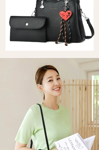 Detail of black litchi leather tote bag with matching wallet and red heart pendant