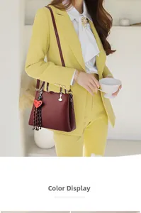 Detailed view of burgundy leather tote with heart-shaped 'Love you' charm and lychee texture