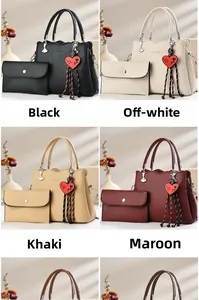 Detail of faux leather handbag set with heart charm and matching wallet in four colors