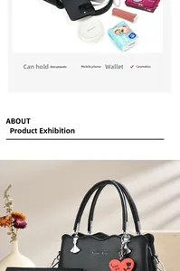 Spacious black leather tote bag showing capacity with phone, cosmetics and camera