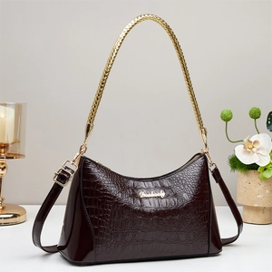 Glossy dark brown crocodile embossed handbag with gold chain handle and leather strap