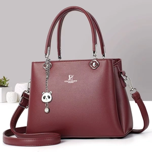 Detailed view of the dark red leather handbag texture and David Jones logo engraving