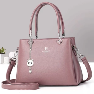 Detail of lychee pattern PU leather handbag with panda pendant and adjustable strap