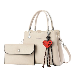 Off-white faux leather tote bag with small envelope pouch and red heart charm