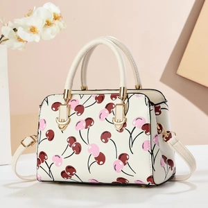 Minimalist cream crossbody bag with pink cherry print and gold hardware for women