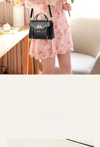 Detail of black PU leather bag with golden swan buckle and fine stitching craftsmanship