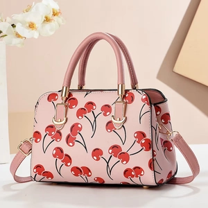 Pink Boston handbag with red cherry patterns and gold metal handles for women