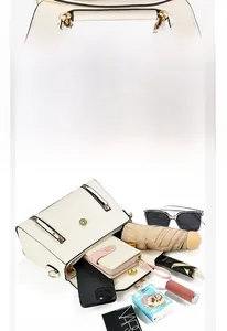 Interior view showing the large capacity of the beige crossbody bag with daily essentials
