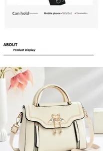 Detail view of cream handbag showing gold swan buckle and capacity for phone and wallet