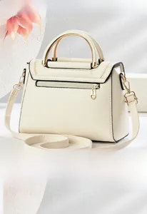 Detailed back view of off-white crossbody bag with heart-shaped zipper and V-shaped stitching