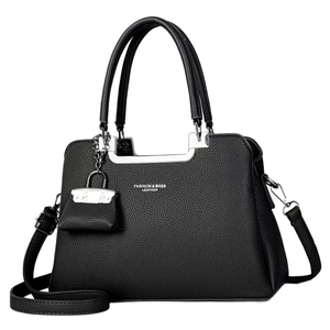 Black pebbled leather tote bag with silver logo and mini charm on white background