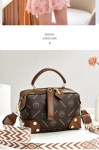 Detail of monogram leather handbag with wide bohemian strap and golden hardware accents