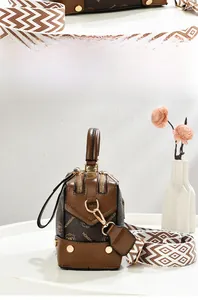 Brown vintage monogram shoulder bag with wide geometric strap and golden rivets