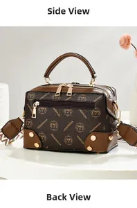 Detail of brown Boston bag featuring dual zippers, gold hardware and metal rivets