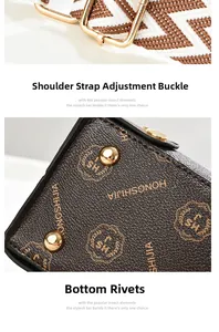 Detail of adjustable woven shoulder strap and protective gold rivets on textured brown bag