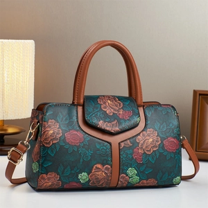 Detail of vintage embossed floral Boston bag with green leather and gold hardware