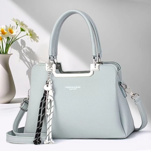 Stylish misty blue lychee texture tote bag with crossbody strap and floral decor