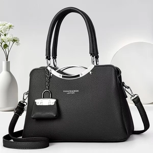 Detail of black pebbled leather tote bag with silver metal trim and mini lock charm