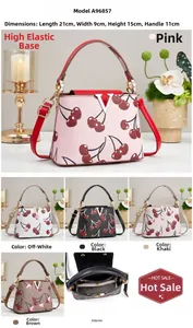 Detail of cherry print handbag with metal V-logo and lychee grain leather texture