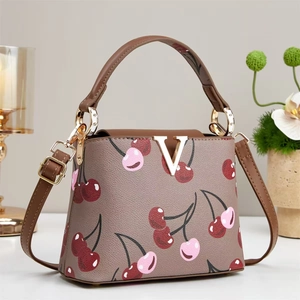Vintage khaki cherry print handbag with gold V buckle and brown leather strap
