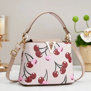 Beige leather bucket bag with cherry print and golden V-shaped buckle hardware