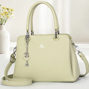 Pale green textured leather tote bag with top handle and detachable shoulder strap