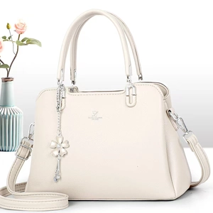 Detail of David Jones Paris beige tote bag with litchi texture and floral tassel charm