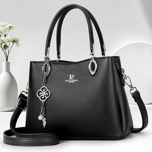 Close-up of black crossbody bag with silver flower charm and David Jones logo