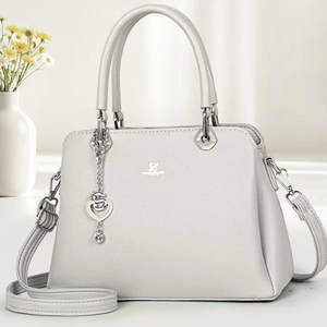 Detail of grey pebble leather handbag with silver heart charm and David Jones logo