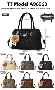 Detailed view of leopard print satchel with plush charm and 7 color options
