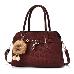 Vintage leopard print burgundy handbag with shoulder strap and plush charm on white background