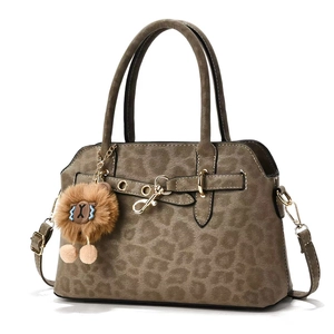 Vintage leopard print tote bag with plush lion charm and adjustable shoulder strap