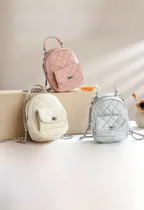 Quilted mini backpacks in pink, white and silver with chain straps and metal locks