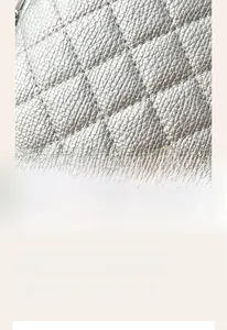 Close-up of silver quilted leather texture showing metallic finish and stitching detail