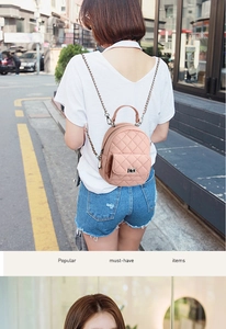 Pink quilted mini backpack shown on model featuring chain straps and a classic twist lock